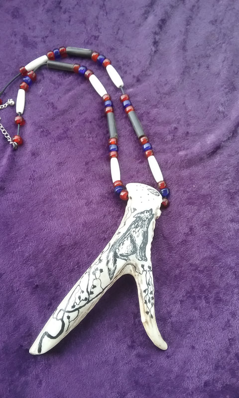 Hand made necklace with pen and ink drawing on antler