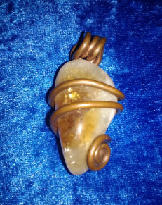 Photo of beautiful copper wrapped polished citrine.